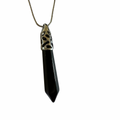 Black obsidian point pendant with ornate silver cap on a snake-chain necklace.