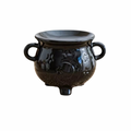 Black ceramic cauldron shape oil and wax melts burner, with handles and little feet on a white background
