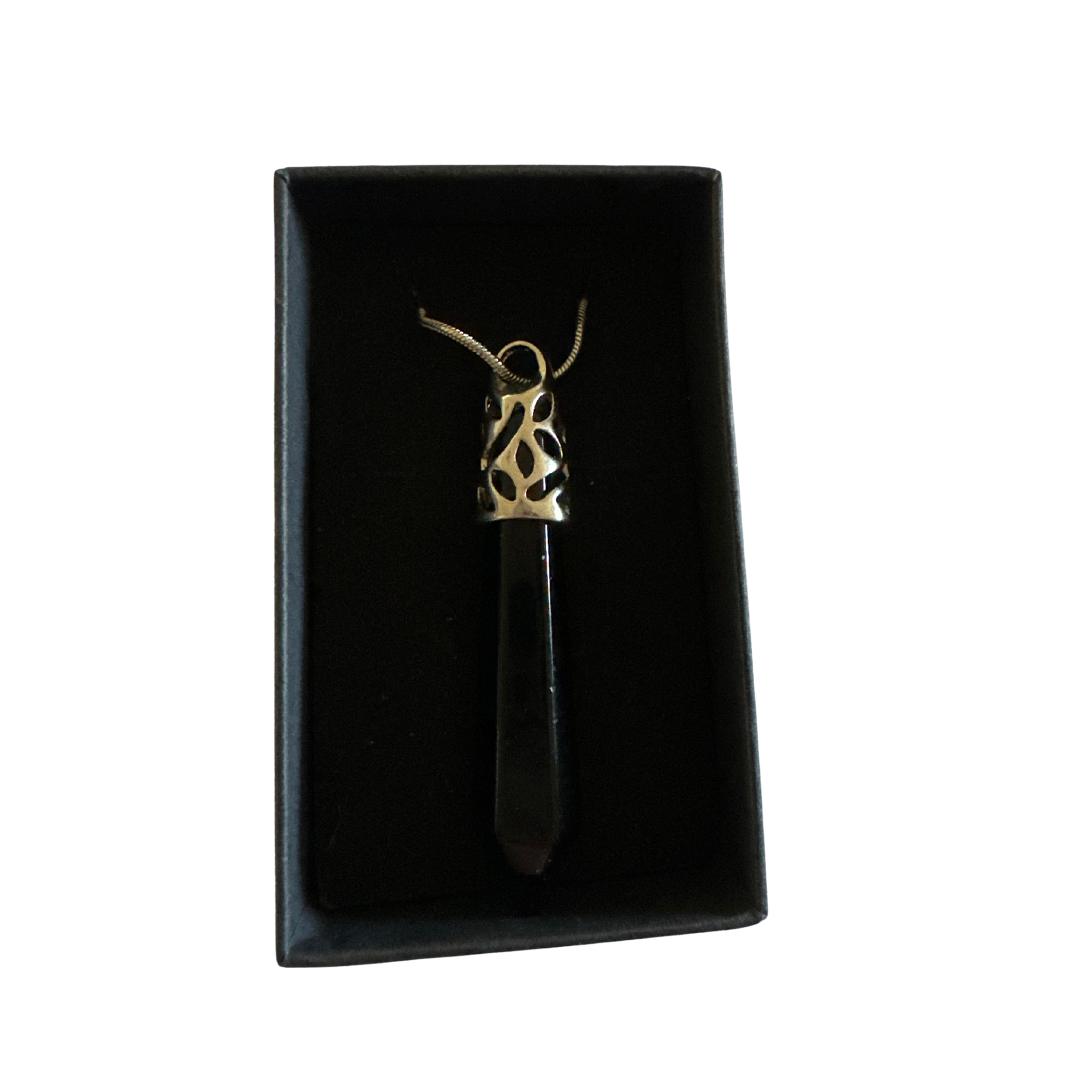 Black obsidian point pendant on a chain in a black jewelry box.