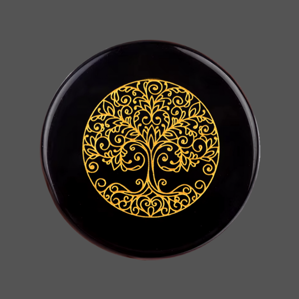 Black obsidian stone with carved image of a tree for meditation or spiritual practice 
