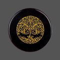 Black obsidian stone with carved image of a tree for meditation or spiritual practice 