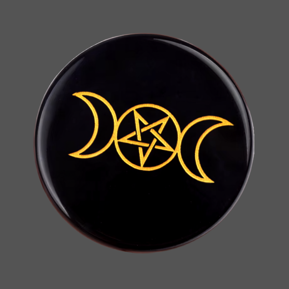 Black obsidian round carved stone rune with triple moon pentagram symbol 