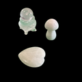 Clear quartz mini crystal set with mushroom, cauldron, heart and sphere on a black backroun 