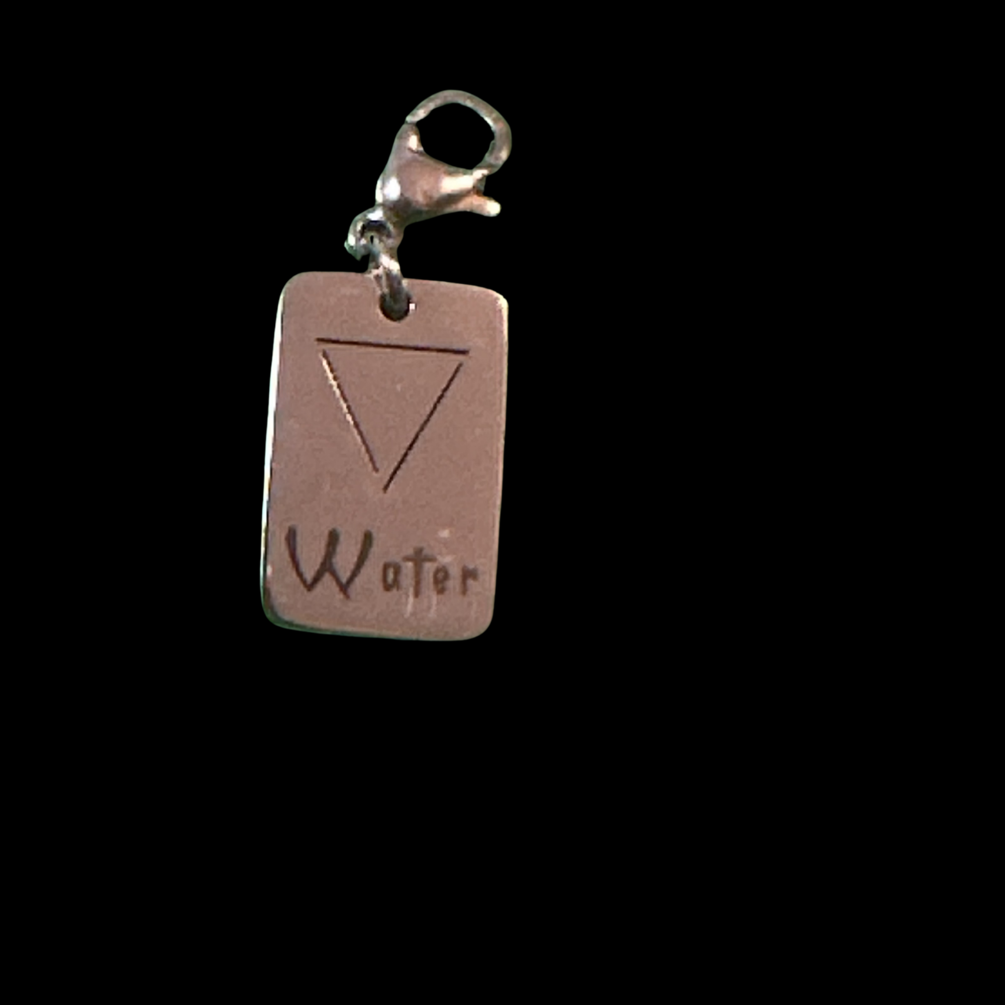 Water Element Charm from Cyn's Signature Jewellery Collection on a pink tag.