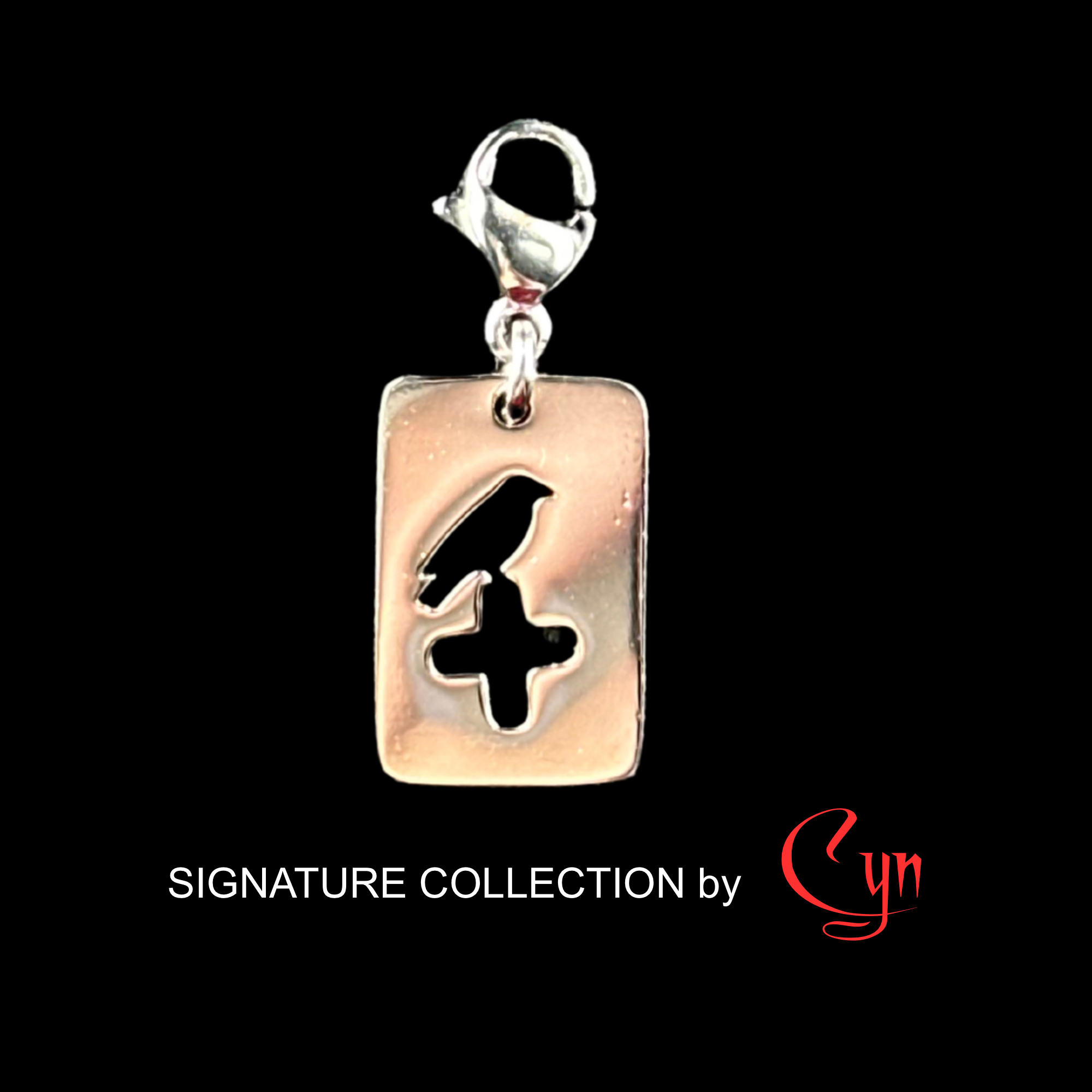 Silver stainless steel rectangular tag featuring a cut out design of a crow sitting on a cross, with a lobster clasp.   on a black background, featuring 'Signature Collection by Cyn'.