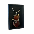 Carnelian Cat Pendant on a silver chain displayed in a black jewelry box.