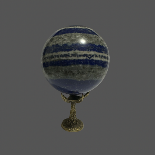 Decorative sphere with blue and gray striped pattern on a claw shape stand against a gray background