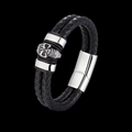 Black leather skull wrist cuff bracelet with silver clasp on a black background