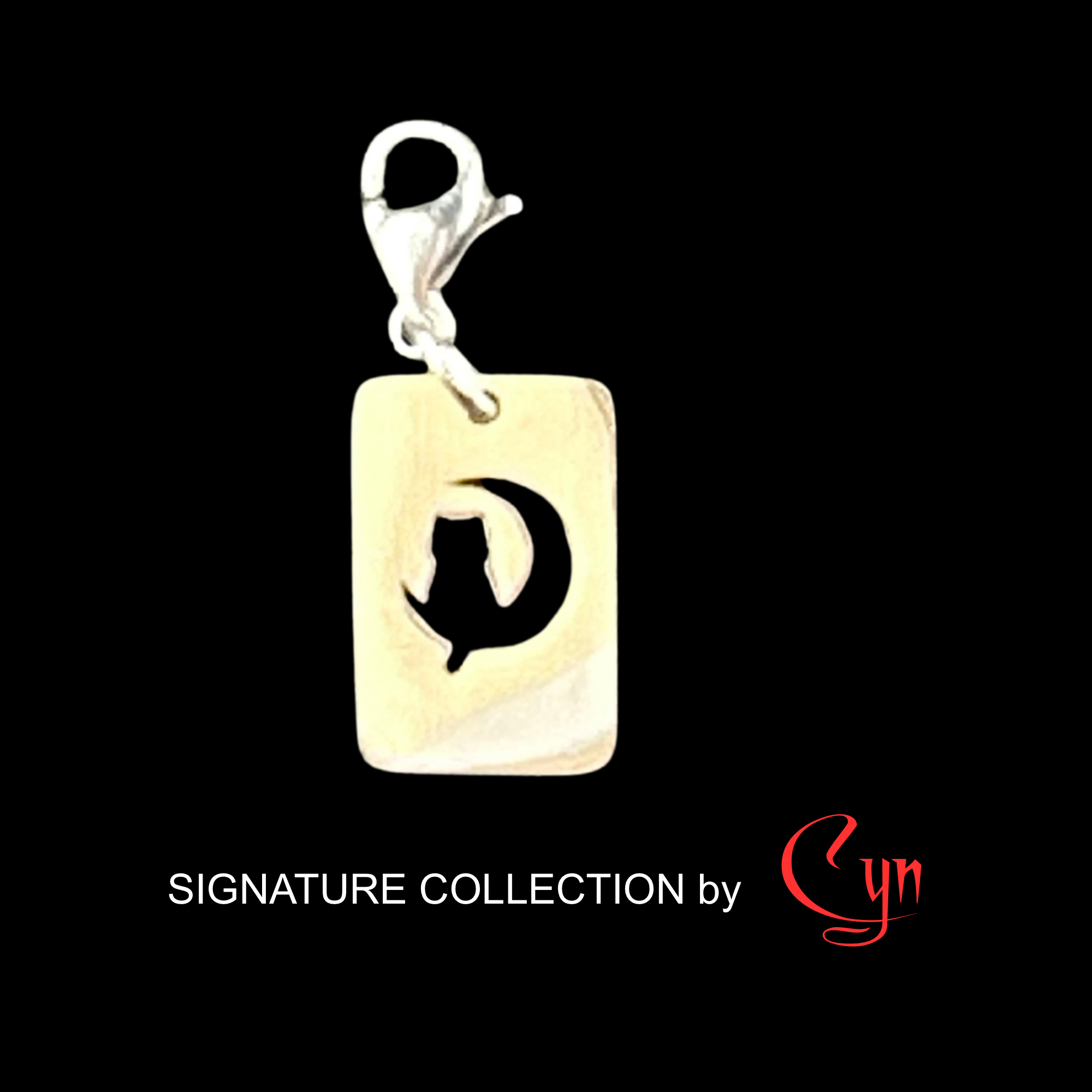 Silver stainless steel rectangular tag featuring a cut out design of a cat sitting on the moon, with a lobster clasp.   on a black background, featuring 'Signature Collection by Cyn'.