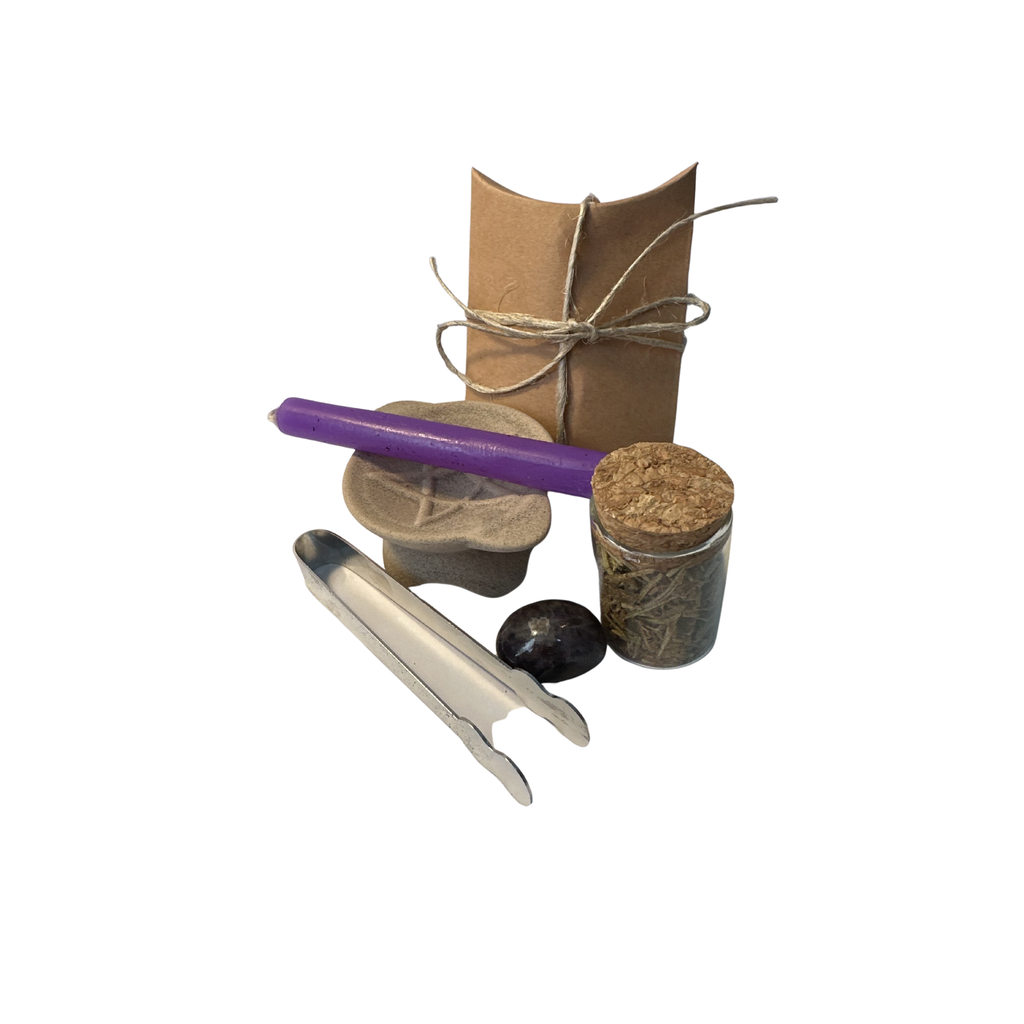 Purification spell casting bundle kit contents on display including candle, crystal, tongs, burner