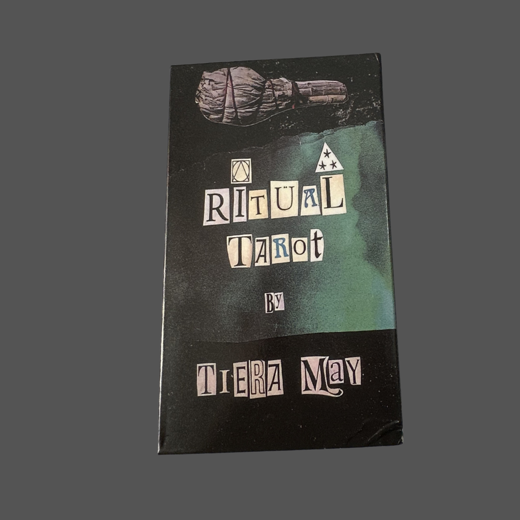 A boxed tarot card deck titled 'A Ritual Tarot' by Tiera May, featuring a black cover with a green gradient section and stylized lettering, photographed against a solid dark gray background.