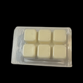 Six small square soy wax melts in a clear plastic pack on a solid black background.