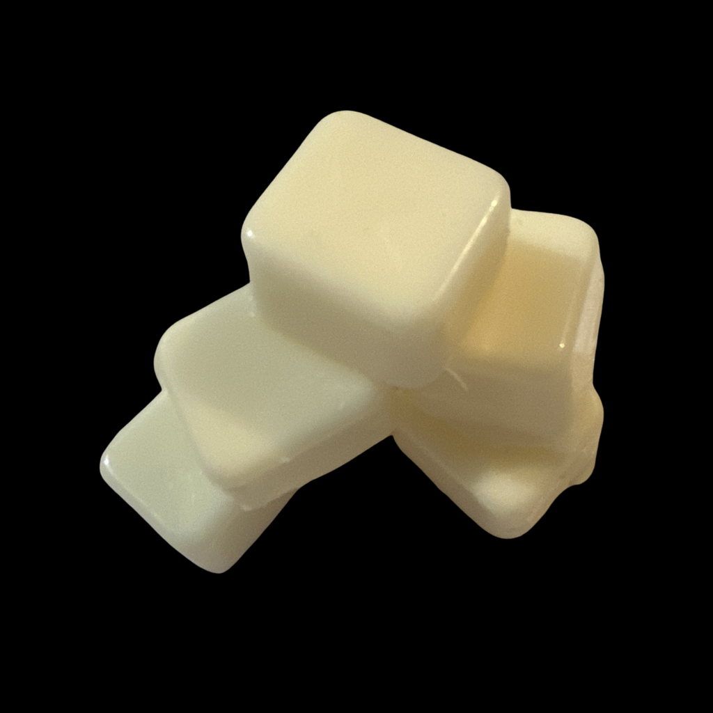 Square soy wax melts minis stacked on a black ba 