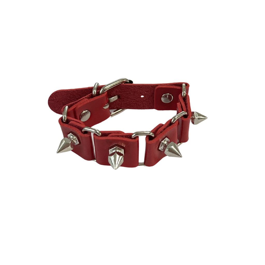 A red pu leather spiked collar with silver-tone metal hardware, including spikes, rings, and a buckle, shown on a plain white background.