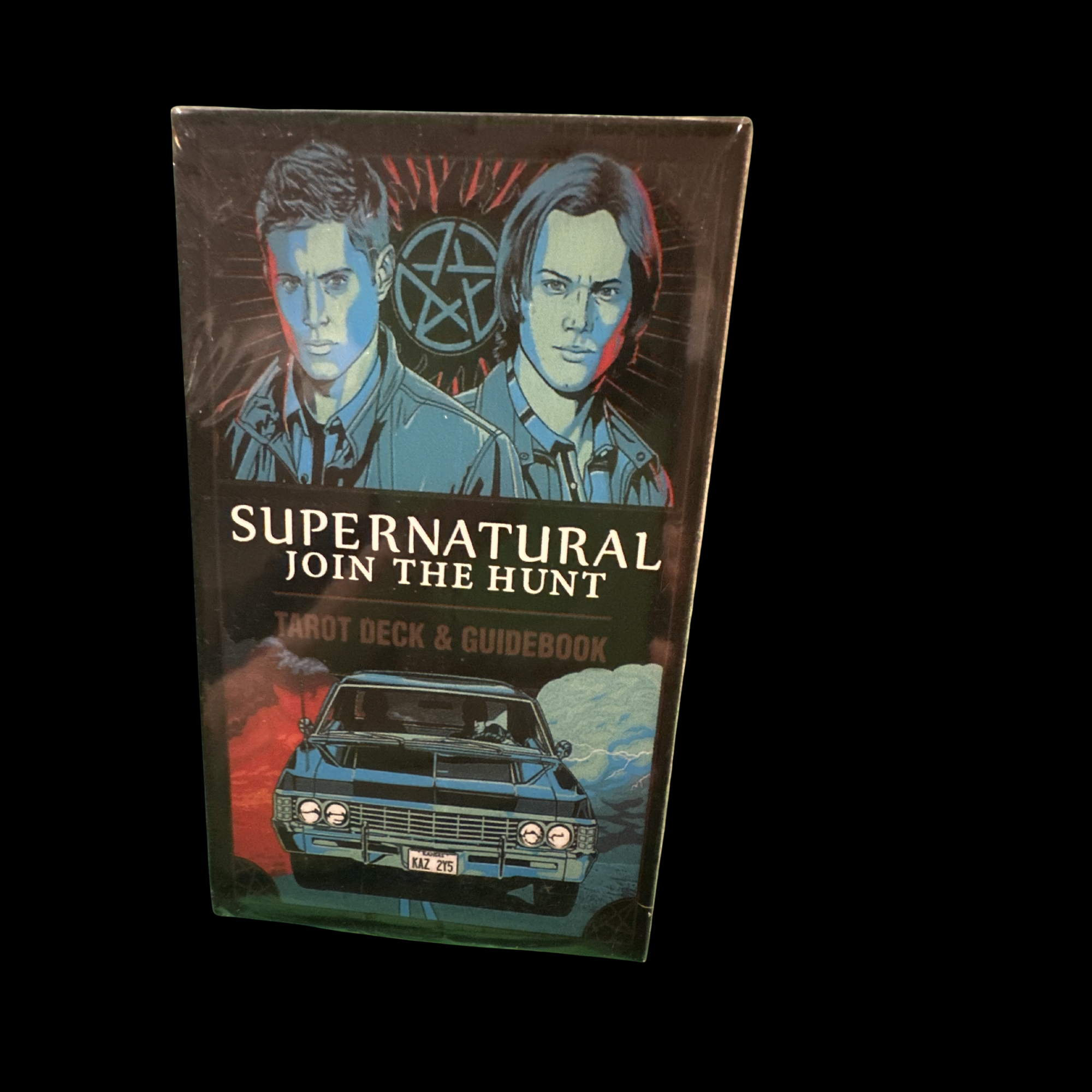 Supernatural tarot deck and guidebook packaging with two characters and a car on a black background